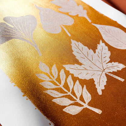 gold acrylic white oil ink autumn wall art linocut print white leaves foraged rustic fall new home gift original artwork thanksgiving table hallway decor grandmother hostess gift one of a kind linogravure botanical office lino cottagecore nature lover leaf farmhouse thank you bedroom printmaking handprinted farm minimalist self sister mom mother hostess new apartment godmother wife woman living room kitchen handmade dining for Her Thankful Gratitude Entryway Dorm Warm Earth Tones Seasonal