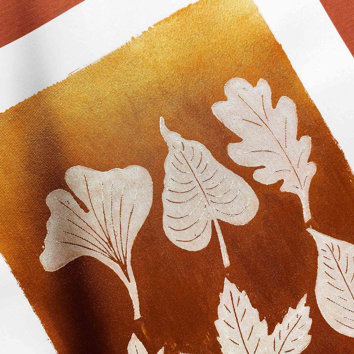 gold acrylic white oil ink autumn wall art linocut print white leaves foraged rustic fall new home gift original artwork thanksgiving table hallway decor grandmother hostess gift one of a kind linogravure botanical office lino cottagecore nature lover leaf farmhouse thank you bedroom printmaking handprinted farm minimalist self sister mom mother hostess new apartment godmother wife woman living room kitchen handmade dining for Her Thankful Gratitude Entryway Dorm Warm Earth Tones Seasonal