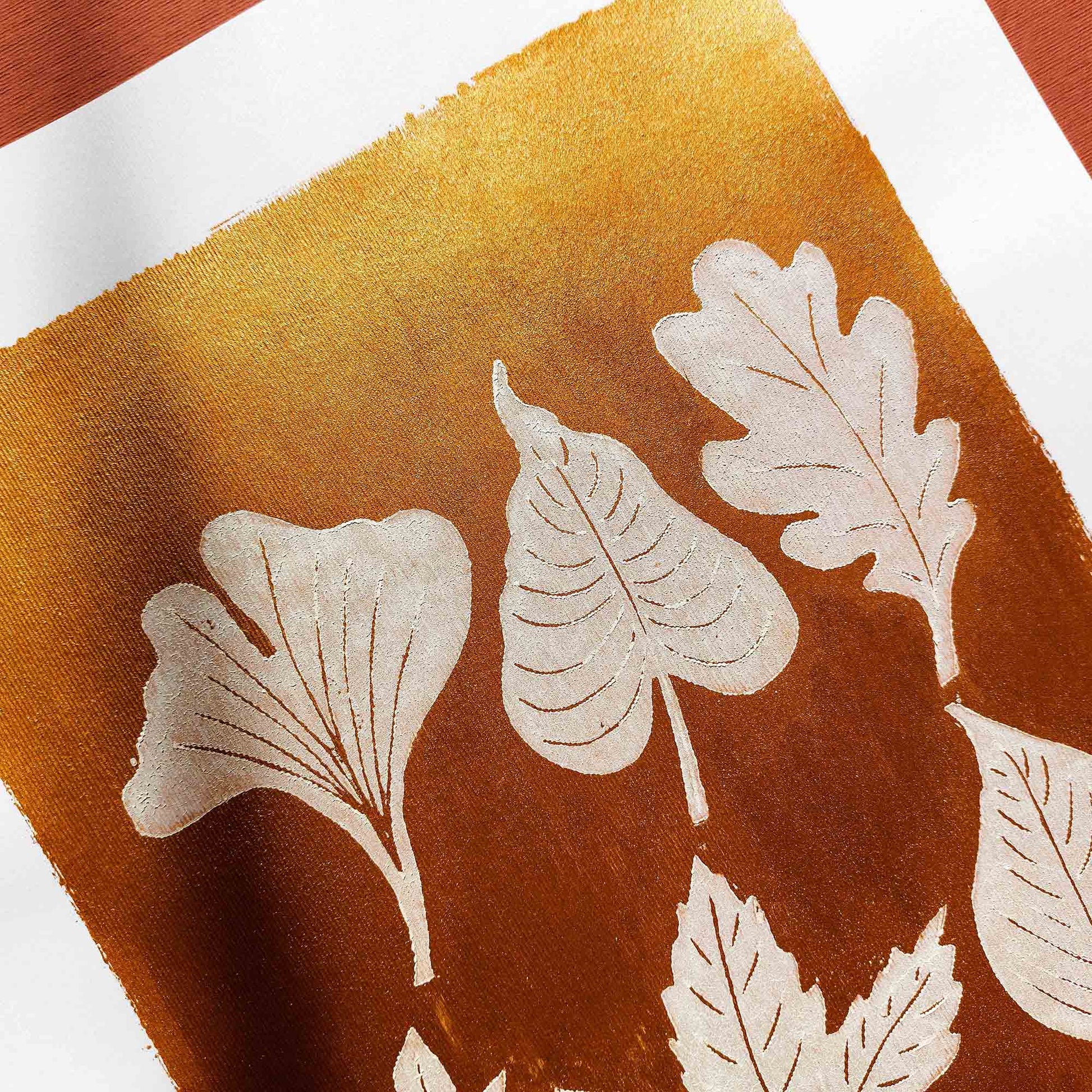 gold acrylic white oil ink autumn wall art linocut print white leaves foraged rustic fall new home gift original artwork thanksgiving table hallway decor grandmother hostess gift one of a kind linogravure botanical office lino cottagecore nature lover leaf farmhouse thank you bedroom printmaking handprinted farm minimalist self sister mom mother hostess new apartment godmother wife woman living room kitchen handmade dining for Her Thankful Gratitude Entryway Dorm Warm Earth Tones Seasonal